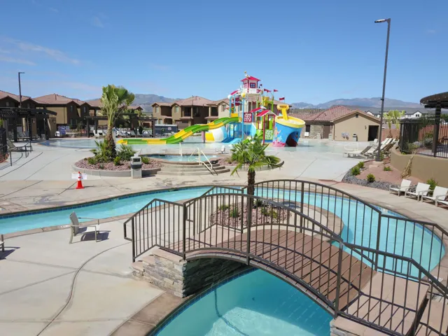 Resort-style aquatic amenity featuring a lazy river, water play structure, and multiple swimming areas