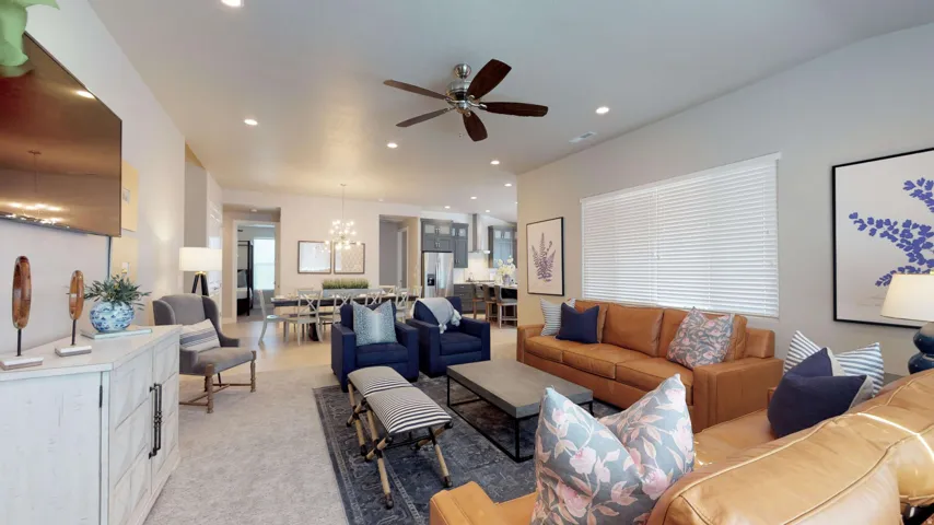 Open-concept living area with recessed lighting and a ceiling fan