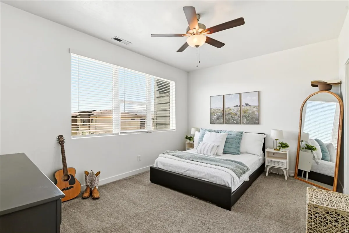 The primary bedroom has a large wndow that brightens the space.
