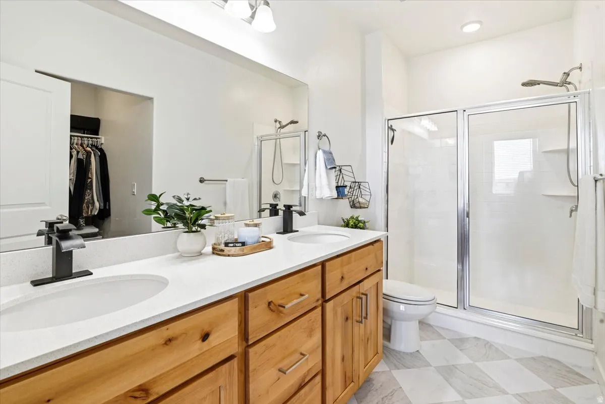 The Primary bathroom has a large shower, double vanity, and access to the walk-in closet.