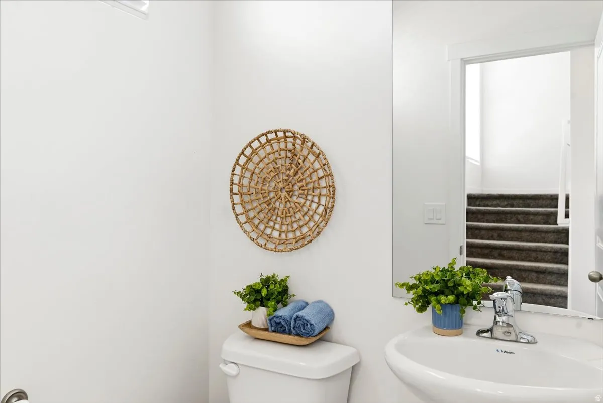 This half bath is conveniently located on the entry floor between the garage door and front door.