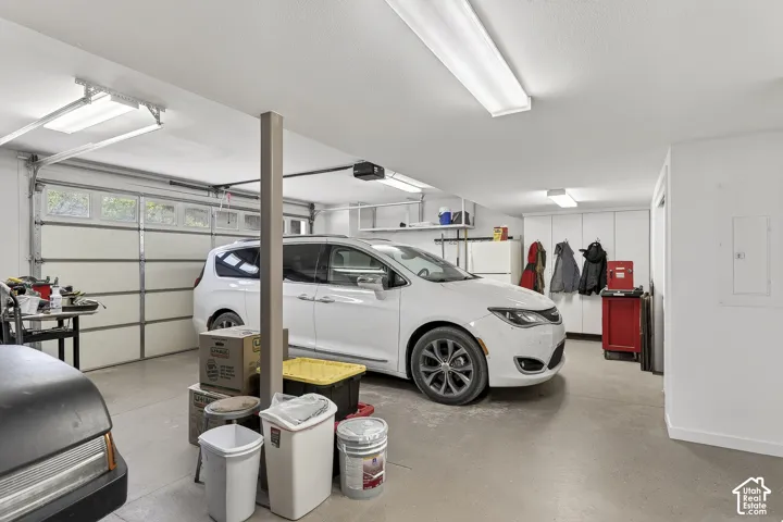 Spacious garage featuring a light gray concrete floor and white walls
