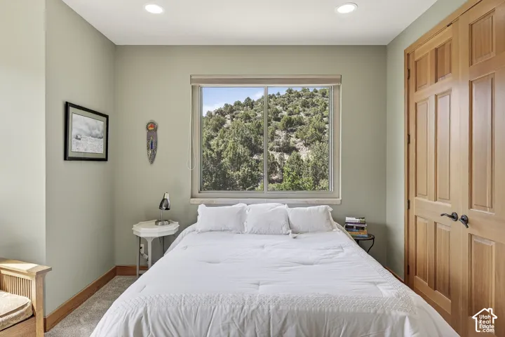 Room with light green walls and recessed lighting