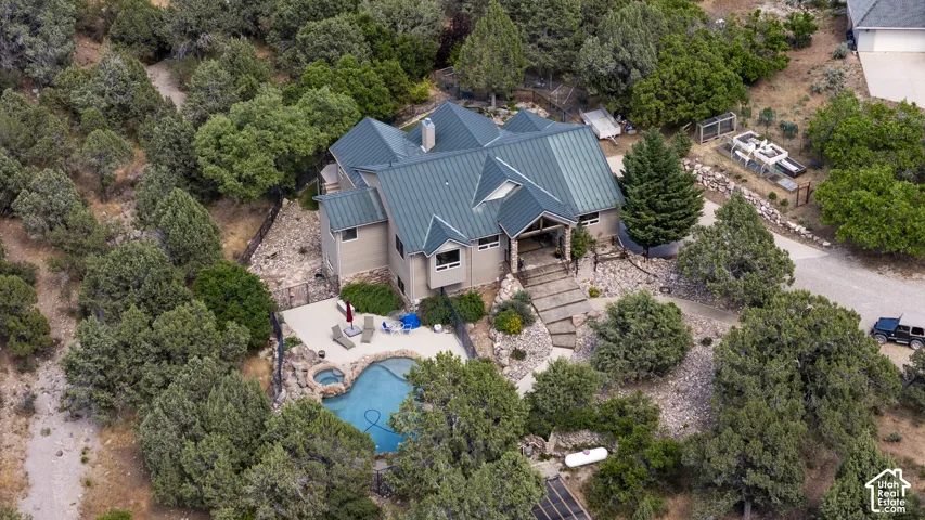 Spacious property featuring a multi-level residence with a distinct metal roof and stone accents