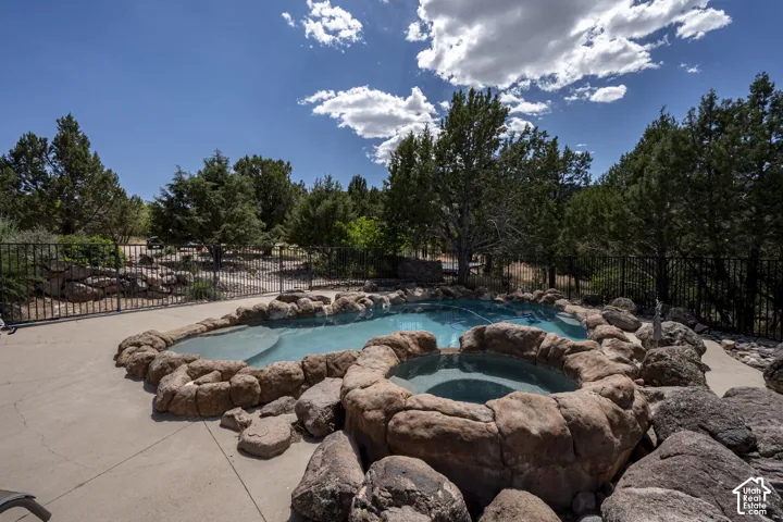 Rock-lined swimming pool with an integrated spa