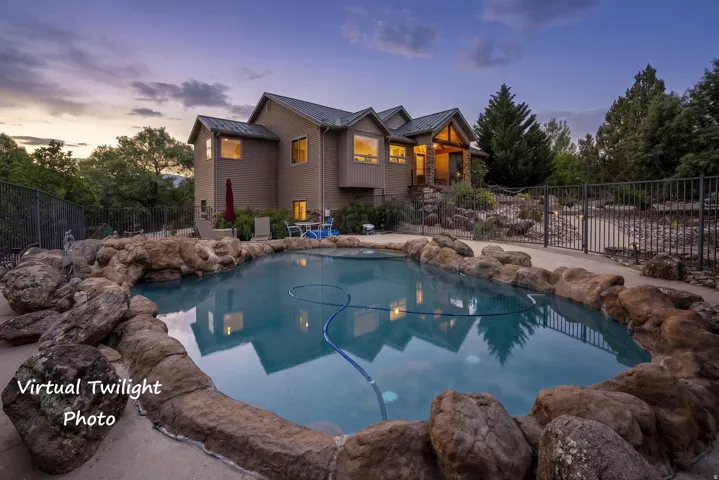 Custom rock-lined swimming pool featuring a curved design and integrated stone coping