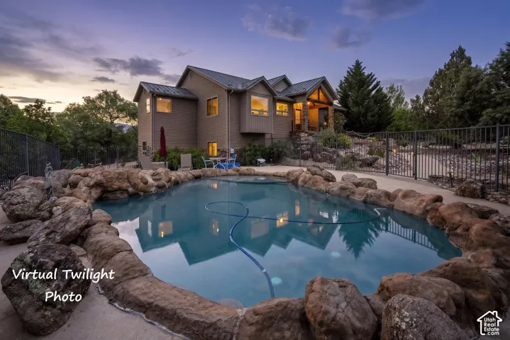 Custom rock-lined swimming pool featuring a curved design and integrated stone coping