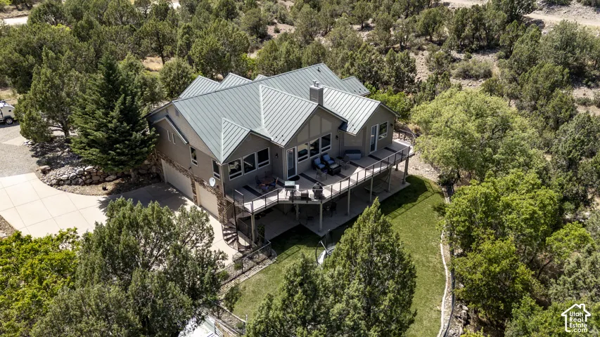 Contemporary residence featuring a metal roof, a multi-level deck, and a spiral staircase
