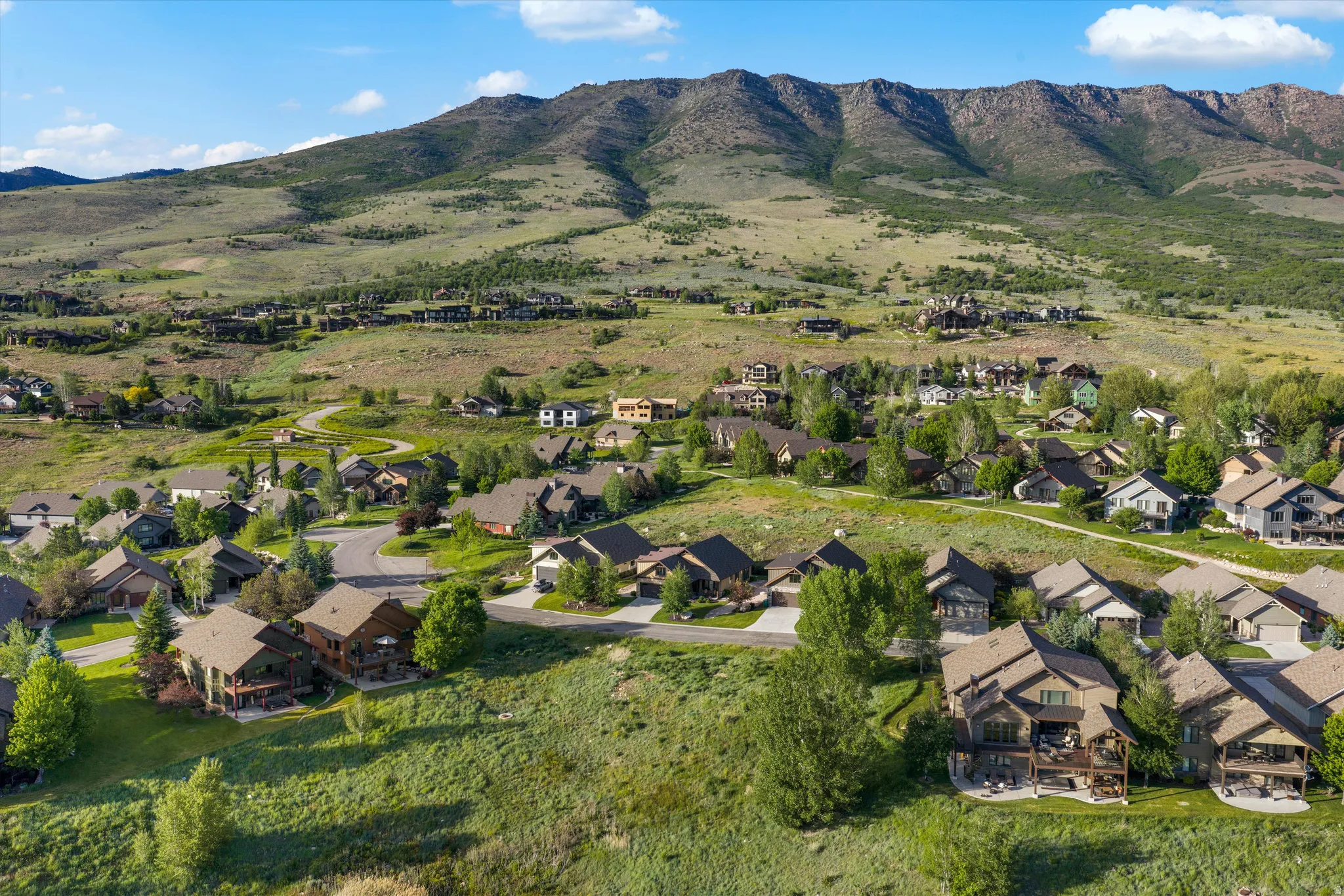 Expansive residential area nestled within a lush, mountainous landscape