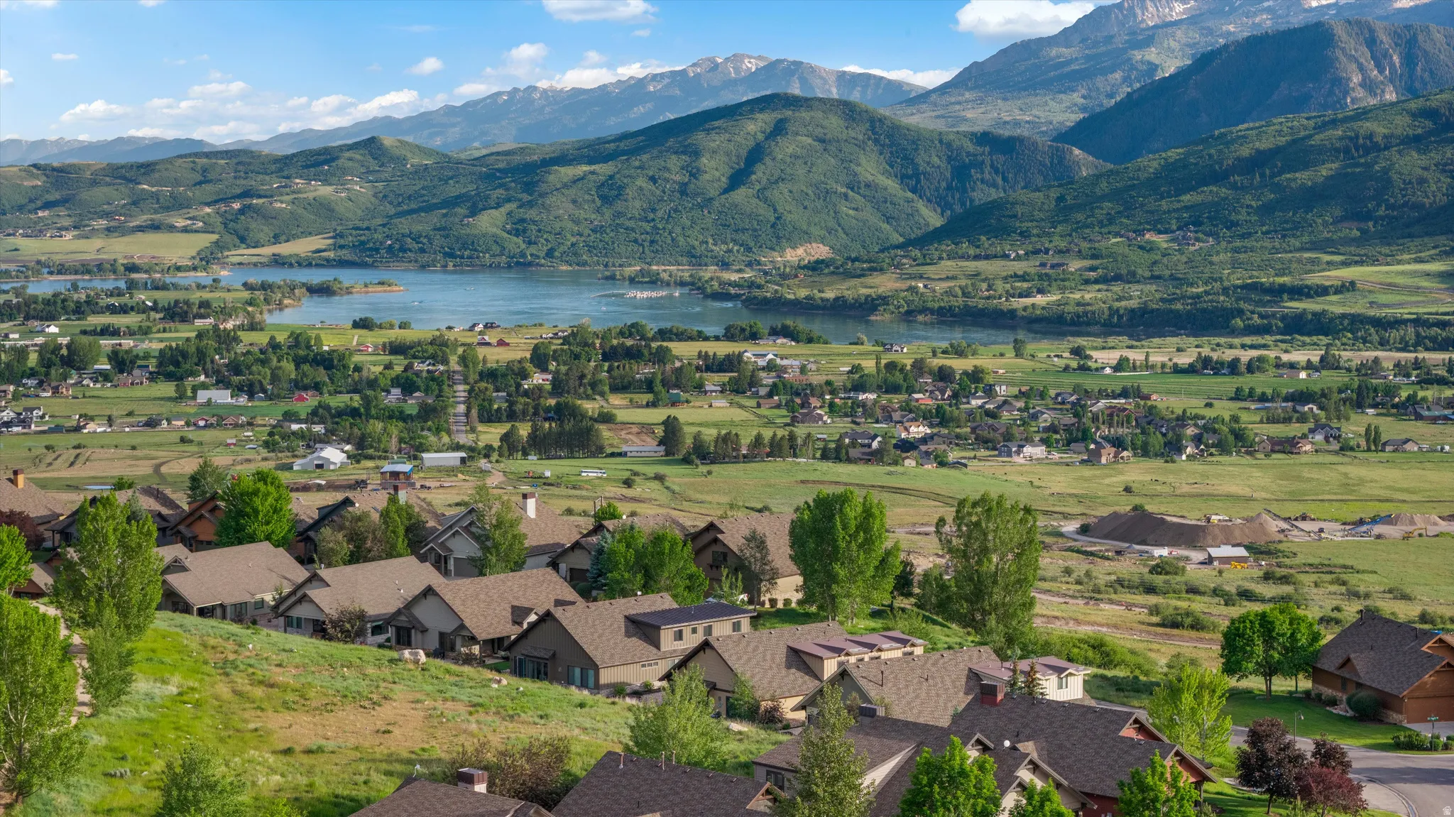 Expansive mountain and lake scenery with residential development