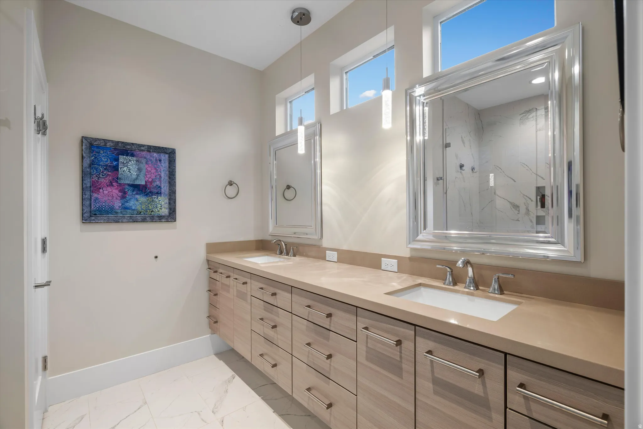Dual vanity featuring wood-finish cabinetry and light-colored countertops