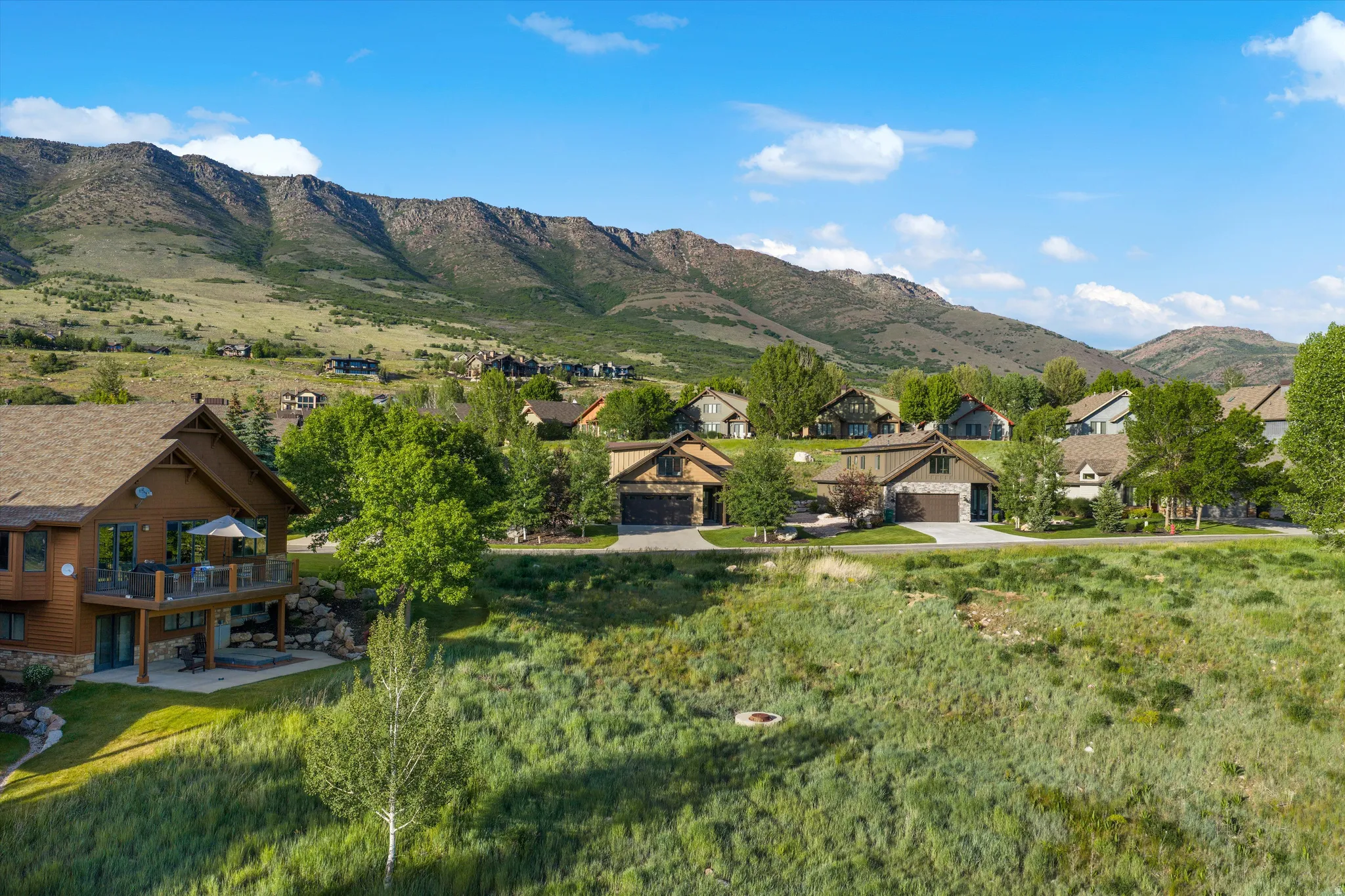 Expansive mountain backdrop framing a residential area with varied architectural styles