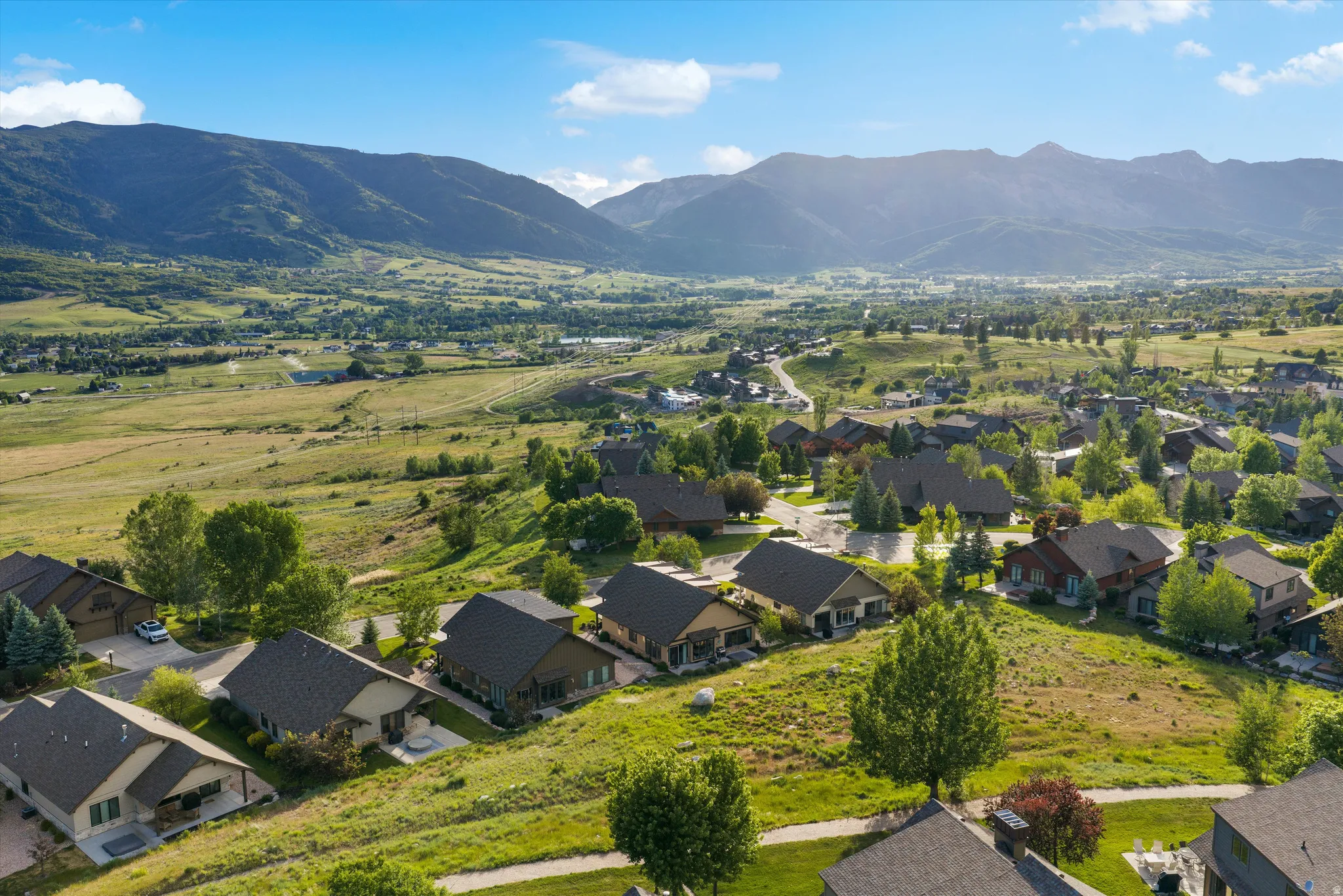 Aerial perspective showcasing a residential community nestled within a mountainous valley