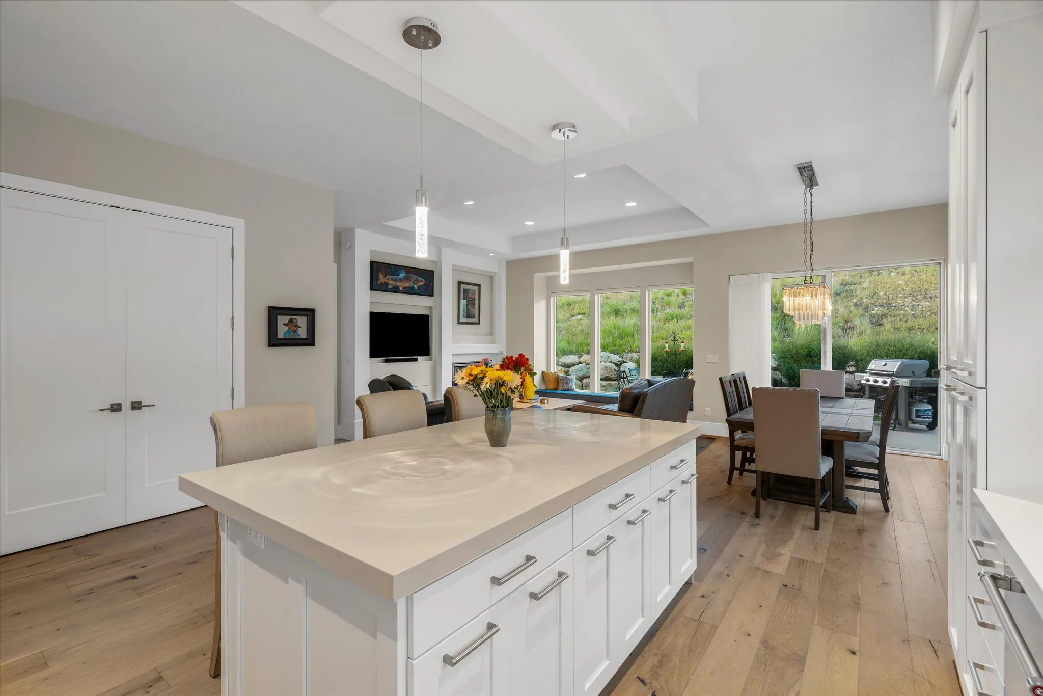 Kitchen island with light-toned countertop and white cabinetry