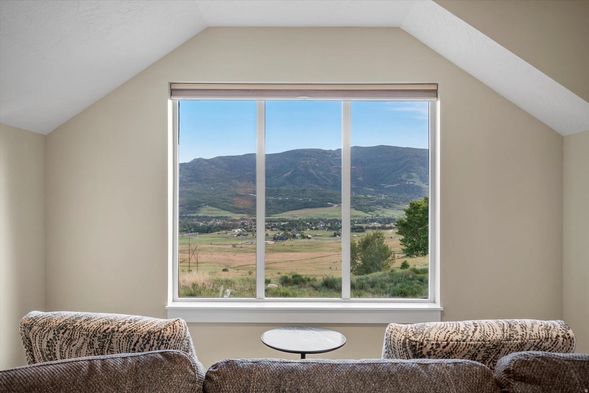 Large picture window showcasing mountain and valley scenery