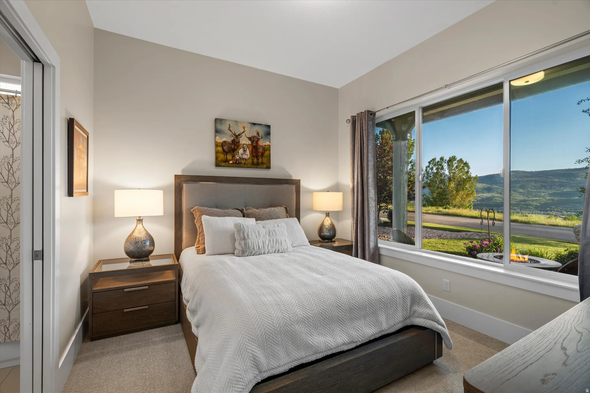 Bedroom featuring a large window, providing expansive views of the surrounding landscape