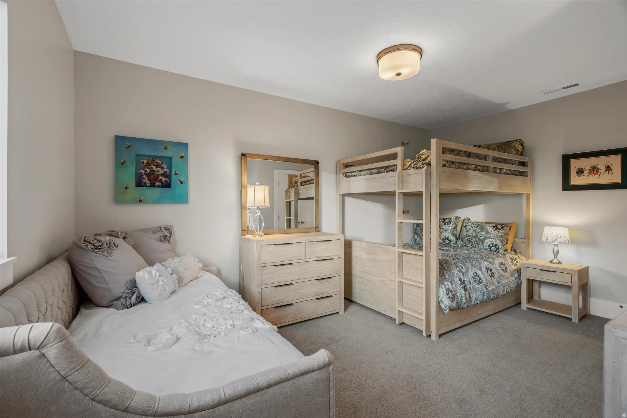 Carpeted bedroom featuring a light-toned bunk bed, a matching dresser with a mirror, and a daybed