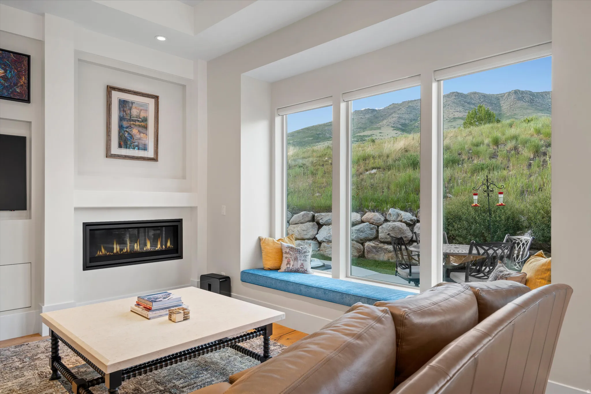 Expansive window wall with mountain scenery and an integrated window seat
