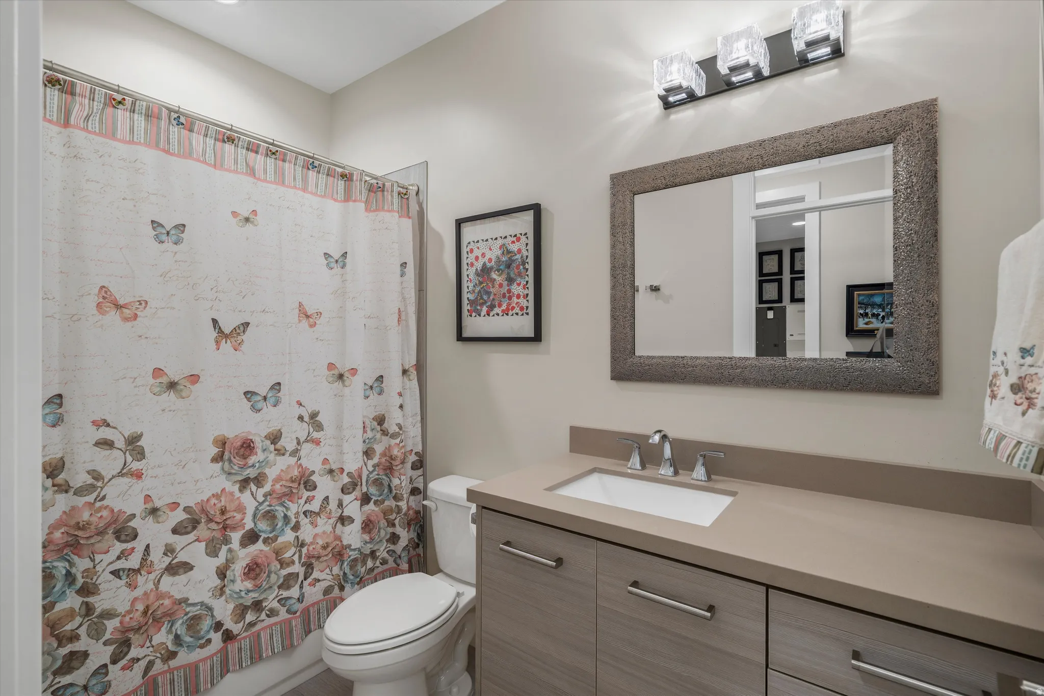 Modern bathroom vanity featuring a rectangular undermount sink and polished chrome faucet