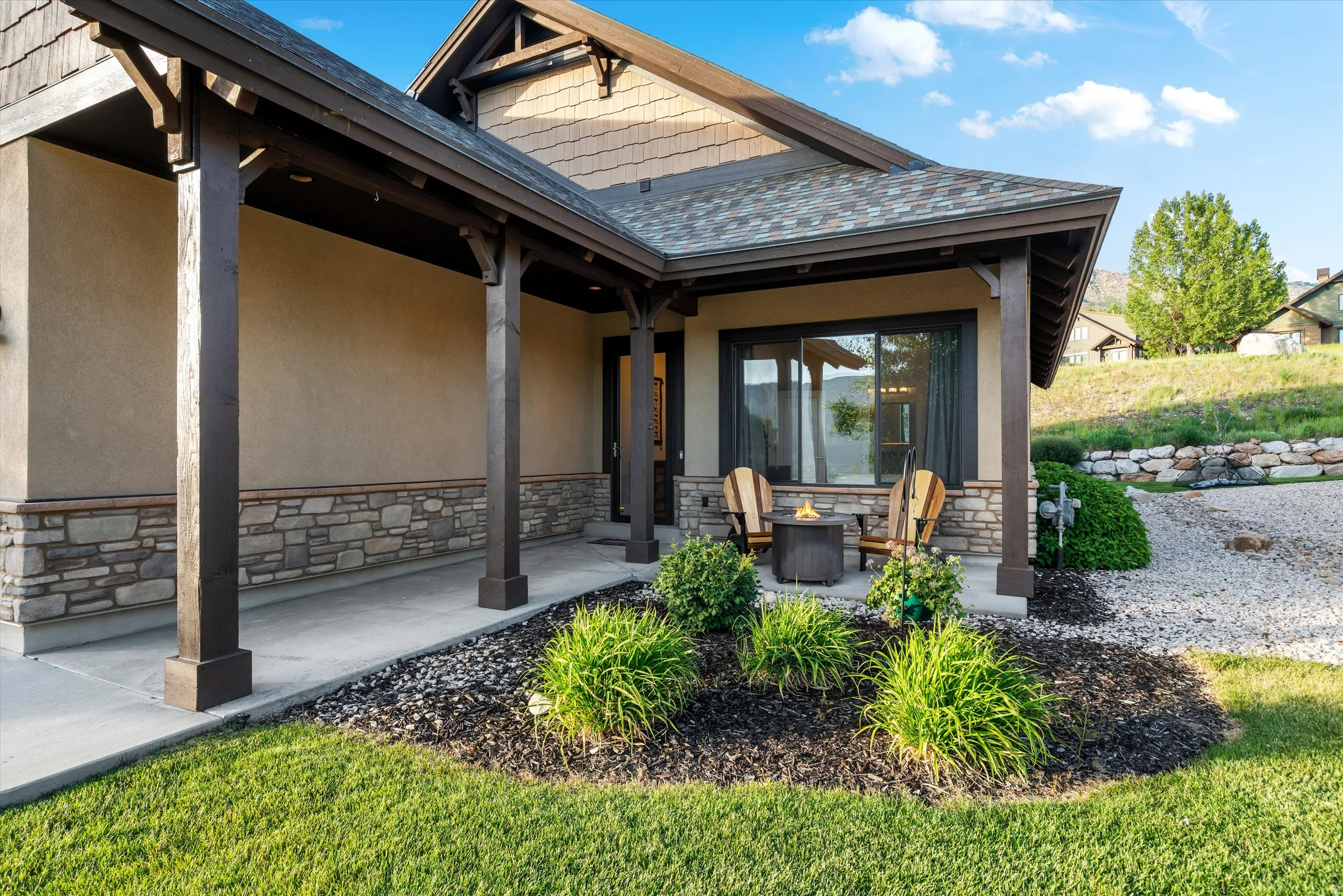 Stucco and stone facade with dark wood architectural accents