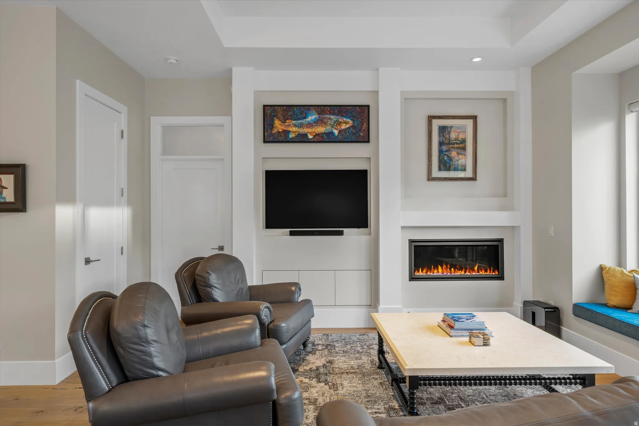 Living area with wood-finish flooring and light-toned walls