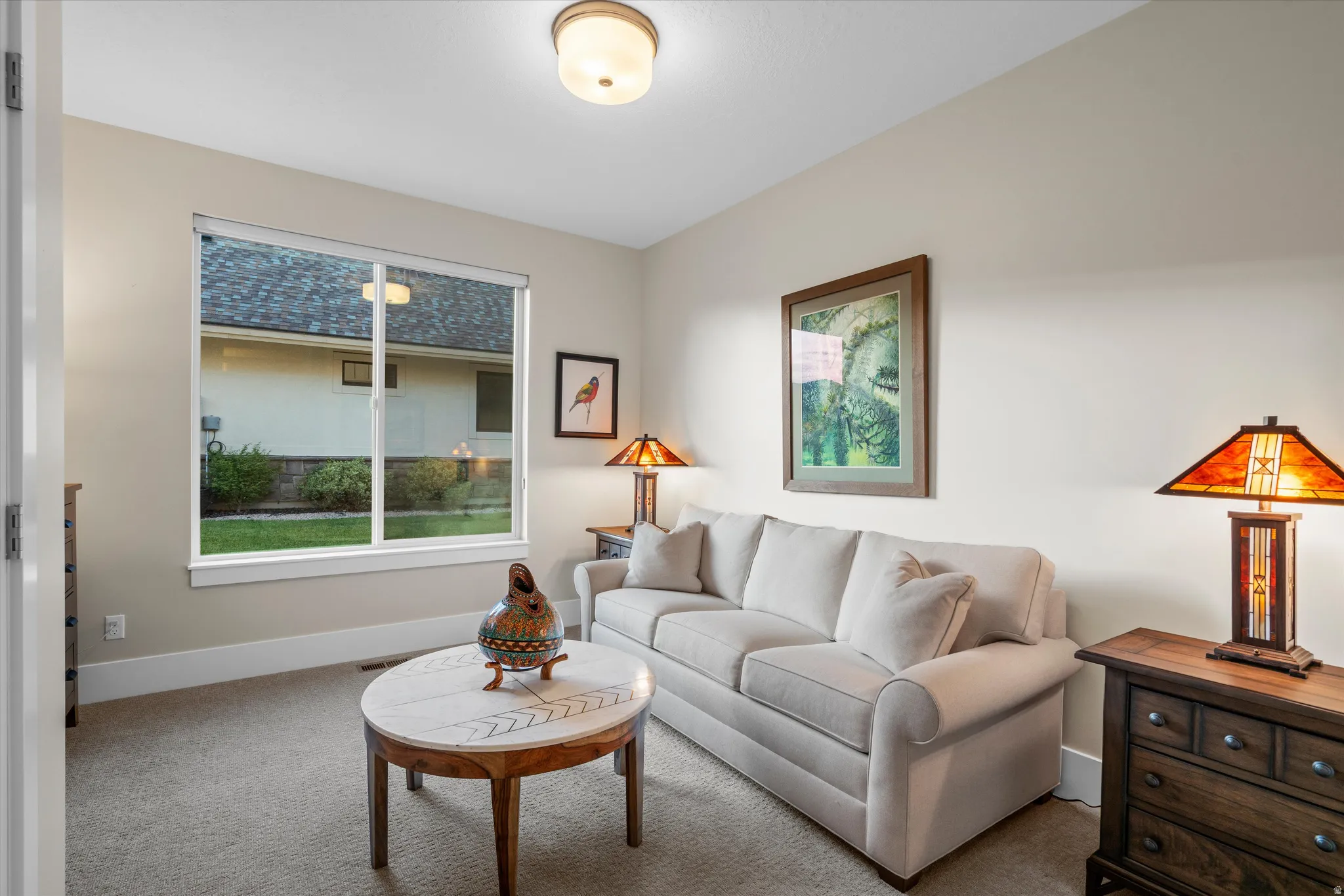 Carpeted room with a large window, neutral wall tones, and recessed lighting
