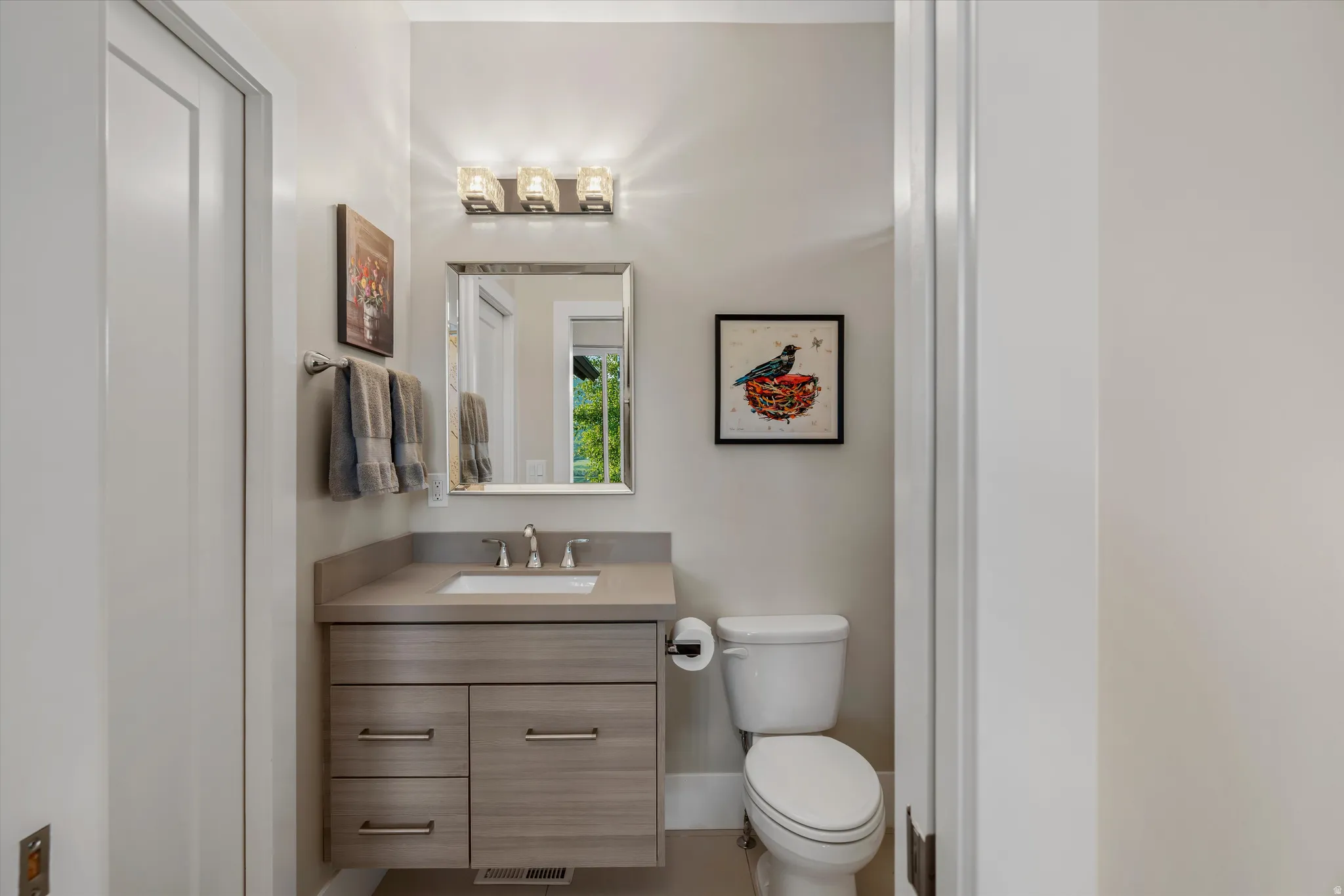 Contemporary vanity with stone-finish countertop and integrated sink