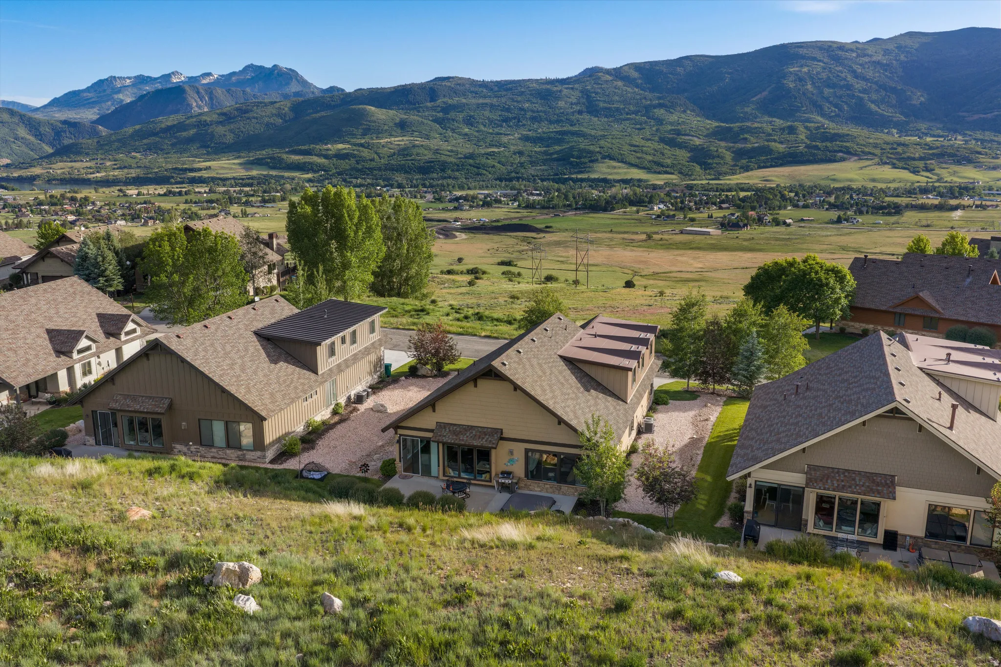 Contemporary mountain home with a distinctive exterior, surrounded by natural landscaping and distant mountain scenery