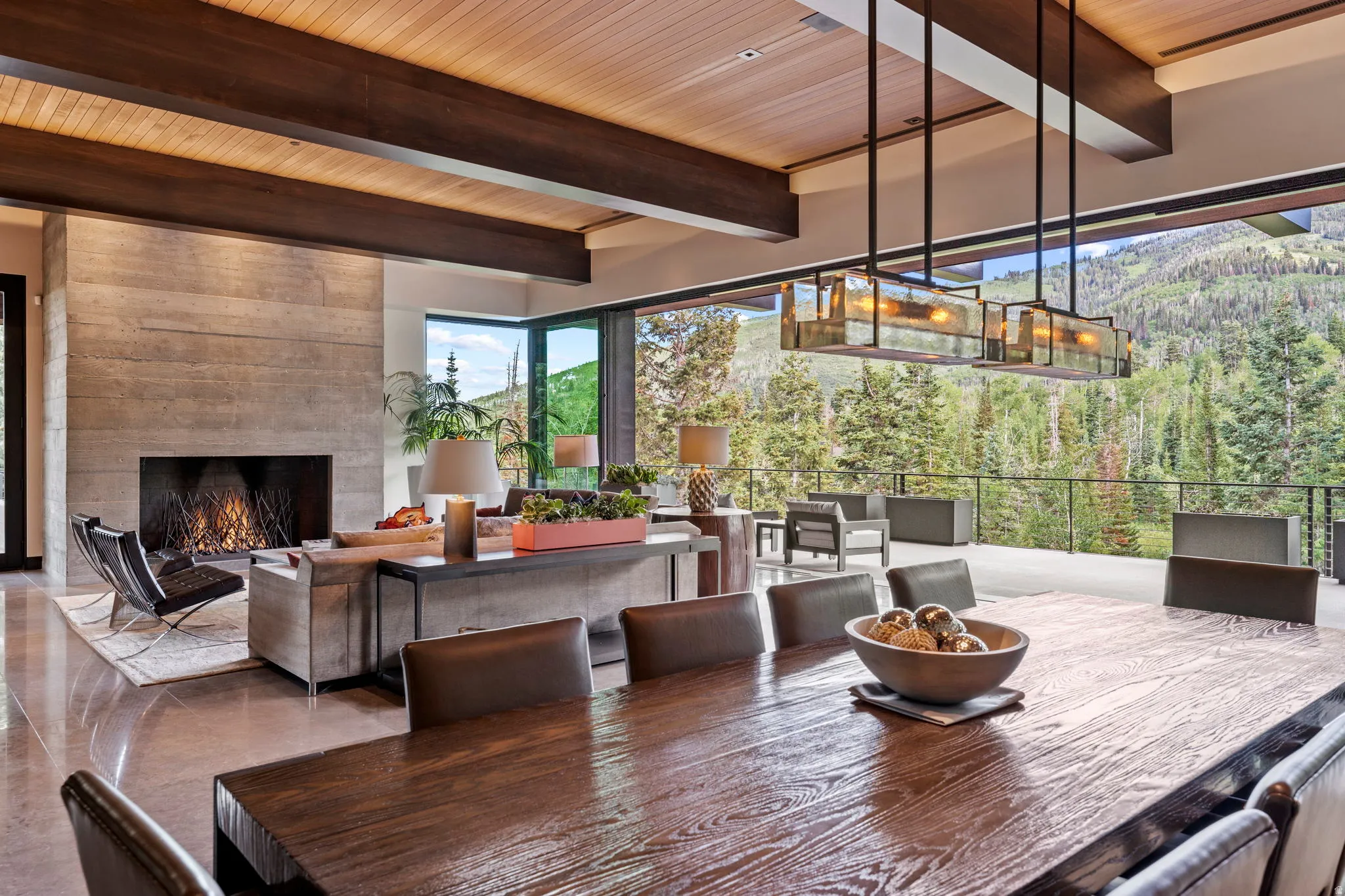 Expansive dining area with a long wood-finish table and leather-style chairs