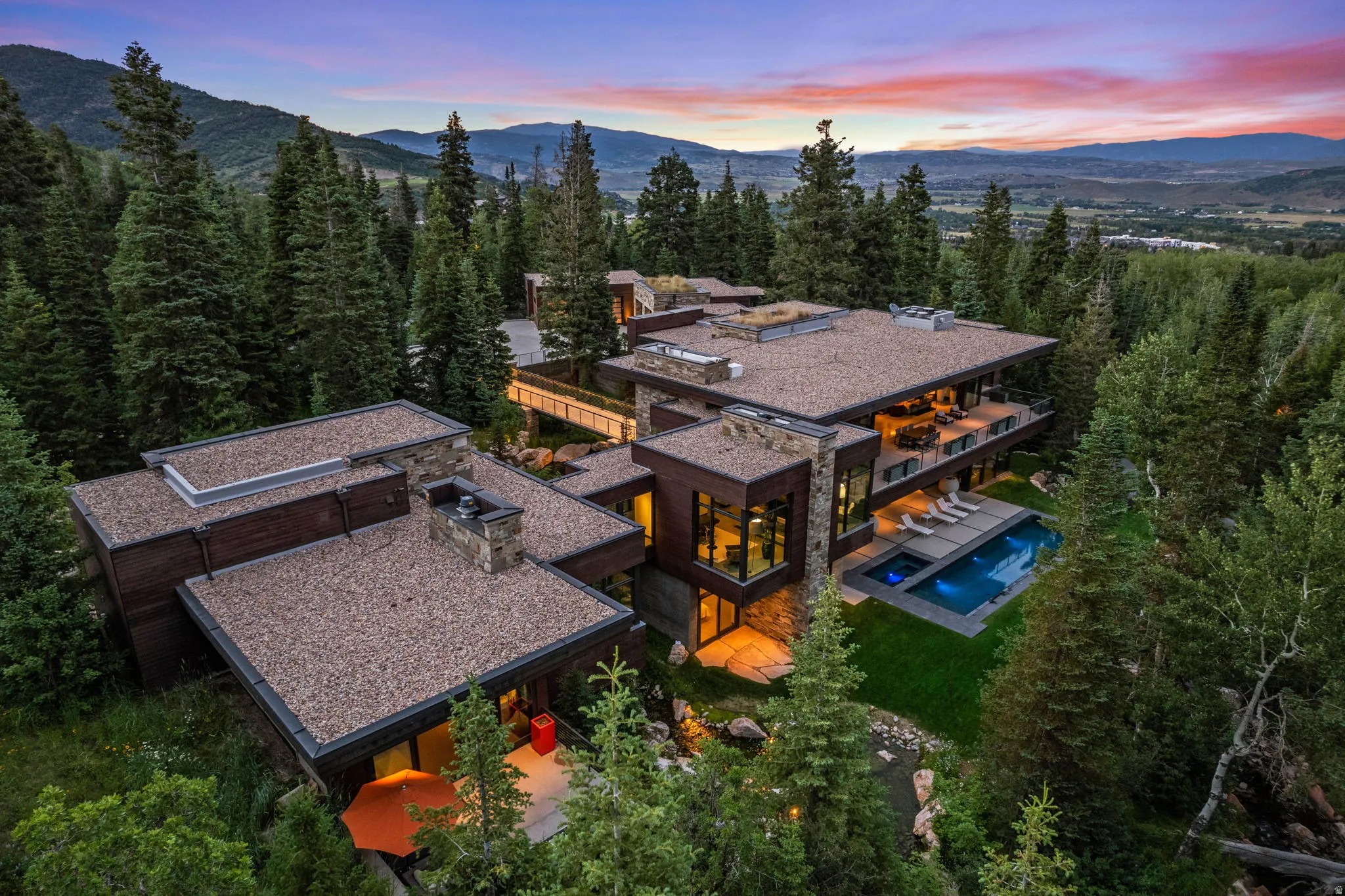 Contemporary residence featuring multiple levels, stone accents, and expansive windows