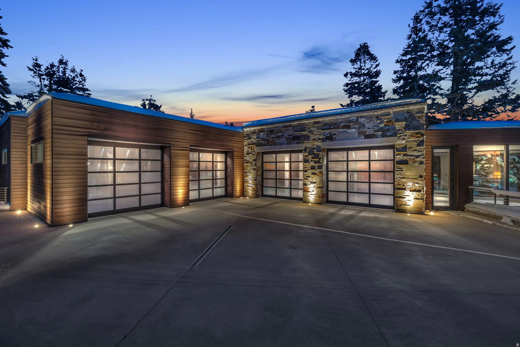 Spacious concrete driveway leading to multiple garage bays