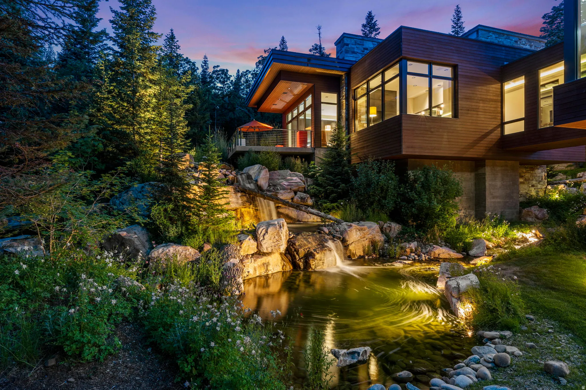 Modern architectural residence featuring extensive wood siding and large window arrays