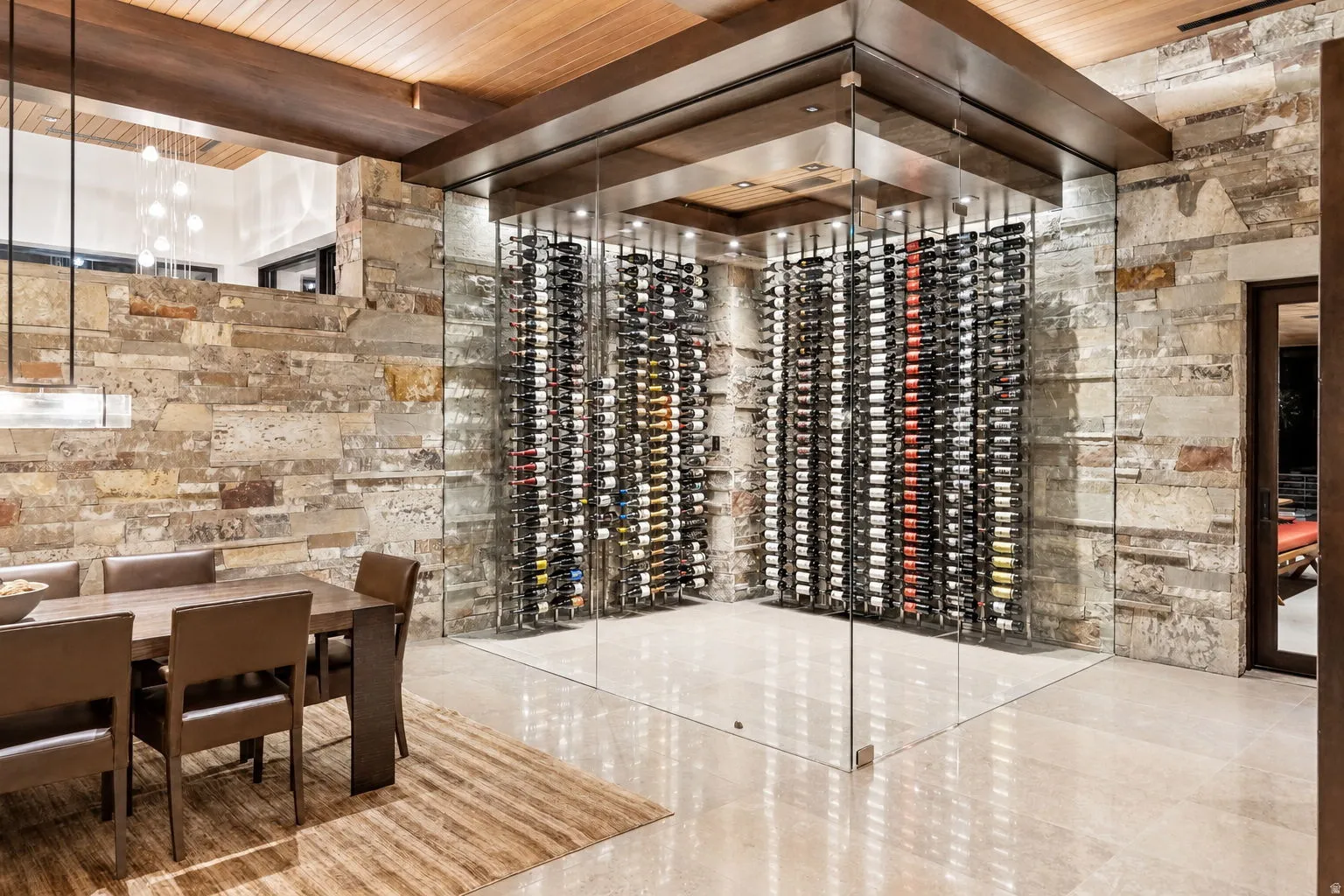 Custom glass-enclosed wine storage featuring built-in racks
