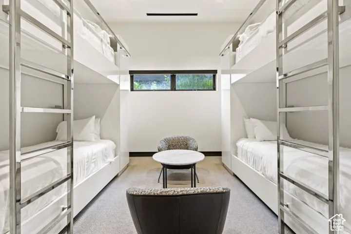 Modern bunk room featuring four built-in bunk beds with integrated ladders