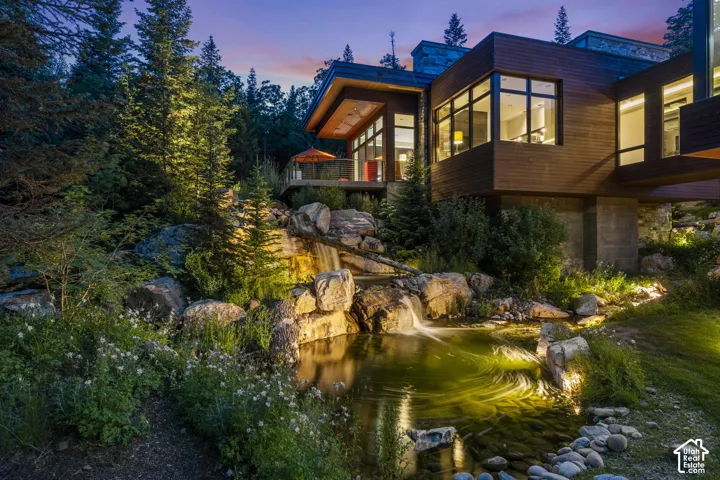 Modern architectural residence featuring extensive wood siding and large window arrays