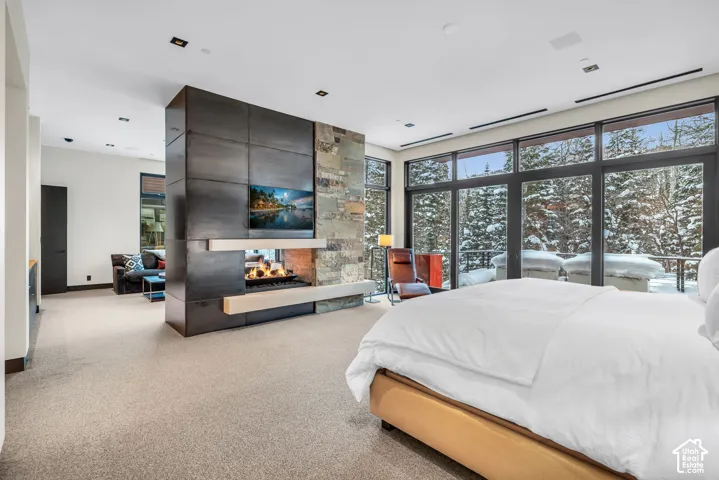 Expansive floor-to-ceiling windows overlooking a snow-covered forest