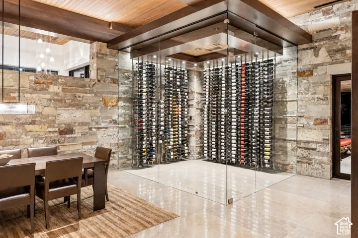 Custom glass-enclosed wine storage featuring built-in racks