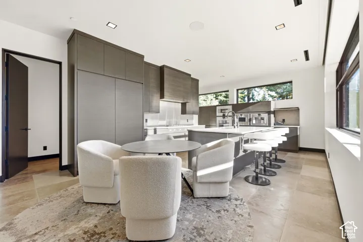 Gourmet kitchen with integrated appliances, large center island, and built-in bar seating