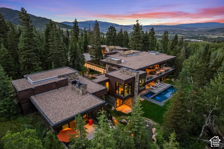 Contemporary residence featuring multiple levels, stone accents, and expansive windows