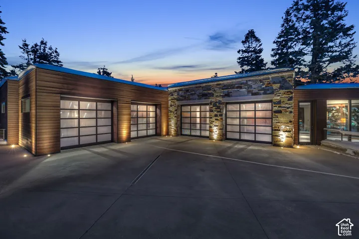 Spacious concrete driveway leading to multiple garage bays