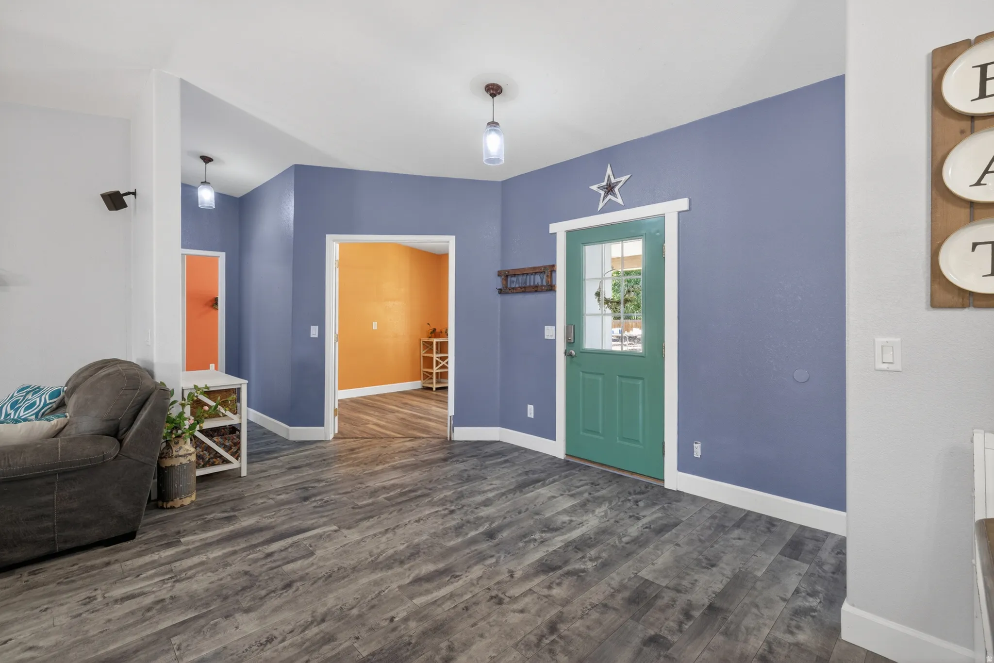 Entryway featuring wood-finish flooring and a green paneled door with glass inserts