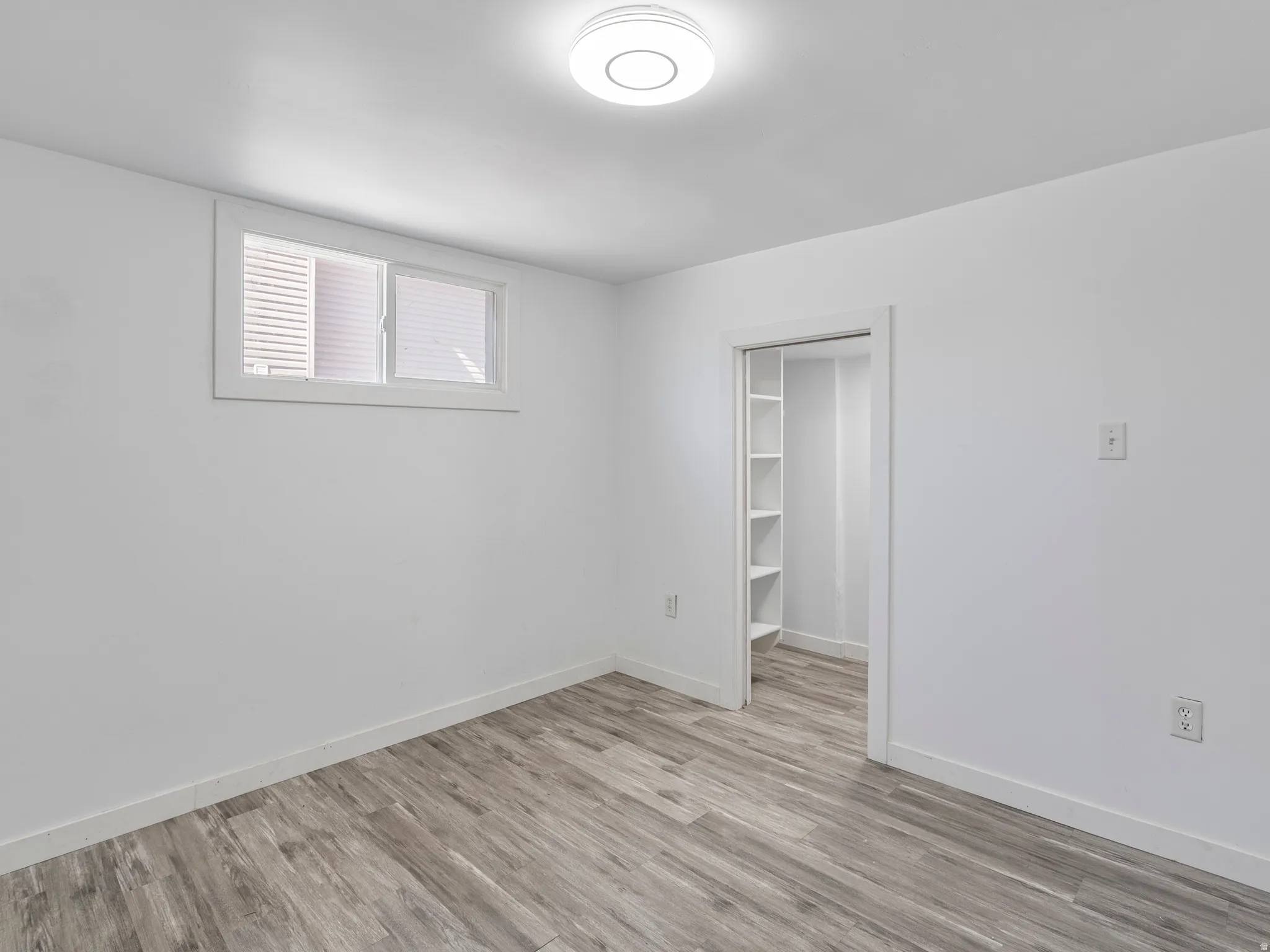Crisp white walls with wood-finish flooring