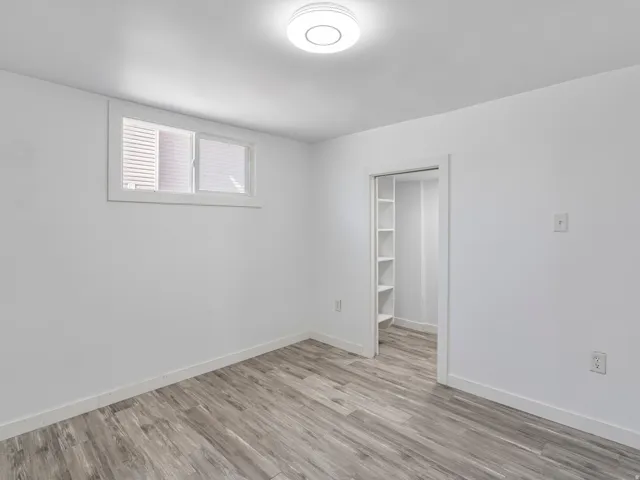 Crisp white walls with wood-finish flooring