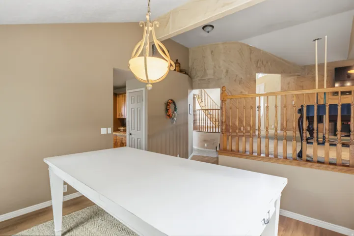 Dining area featuring a decorative chandelier and wood-finish flooring