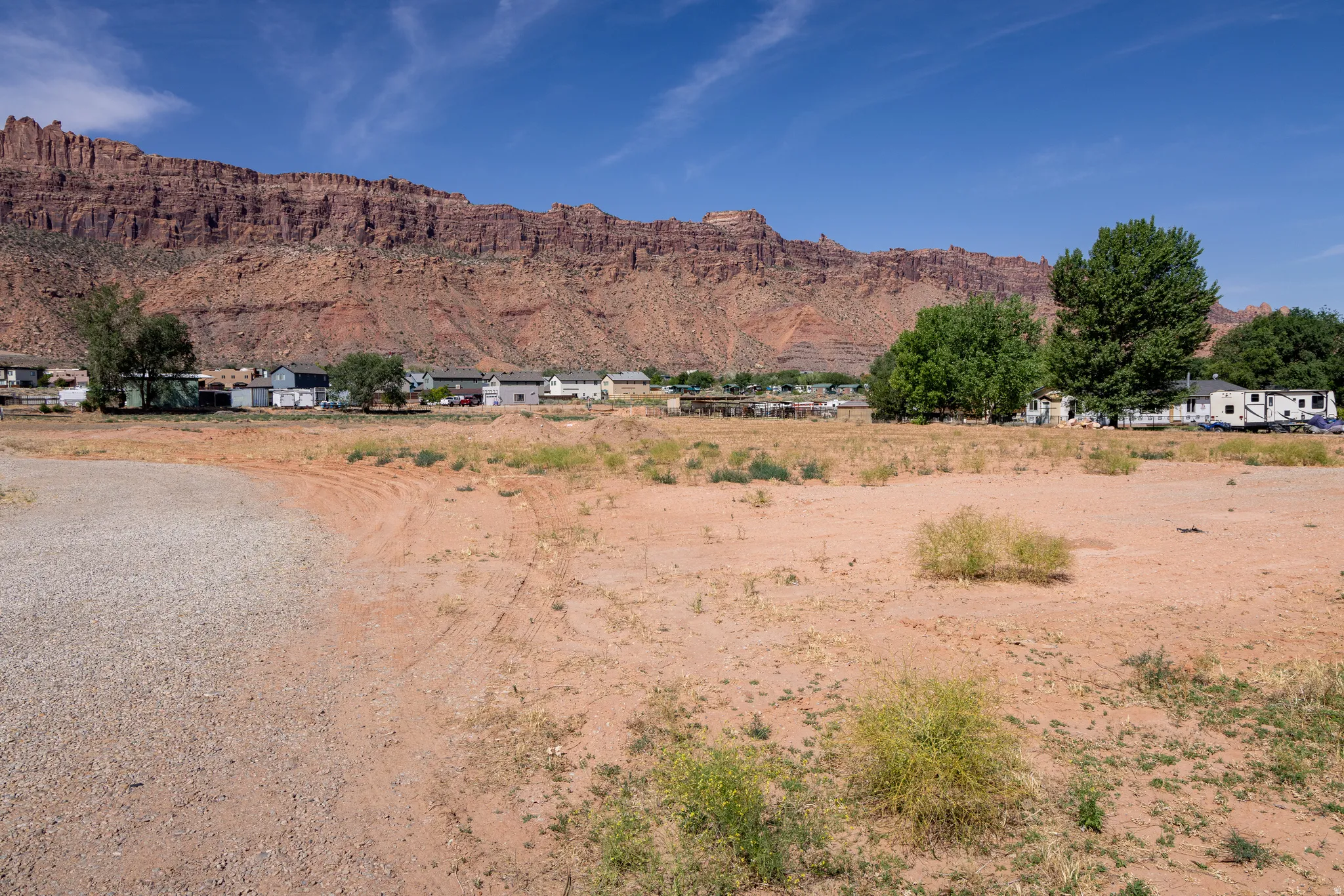 Expansive undeveloped land featuring a gravel portion and arid terrain