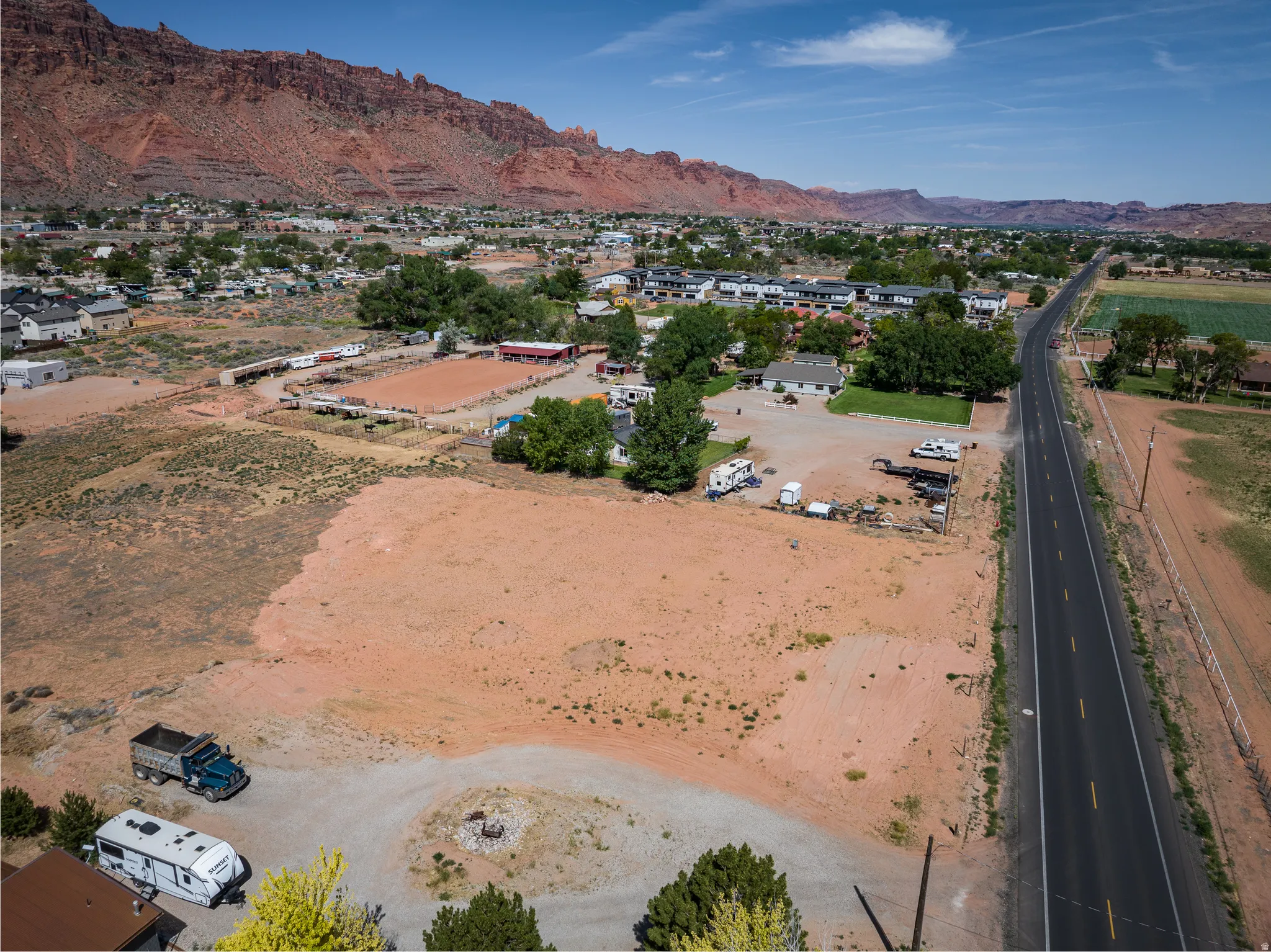 Expansive undeveloped lot featuring a gravel drive and direct road frontage
