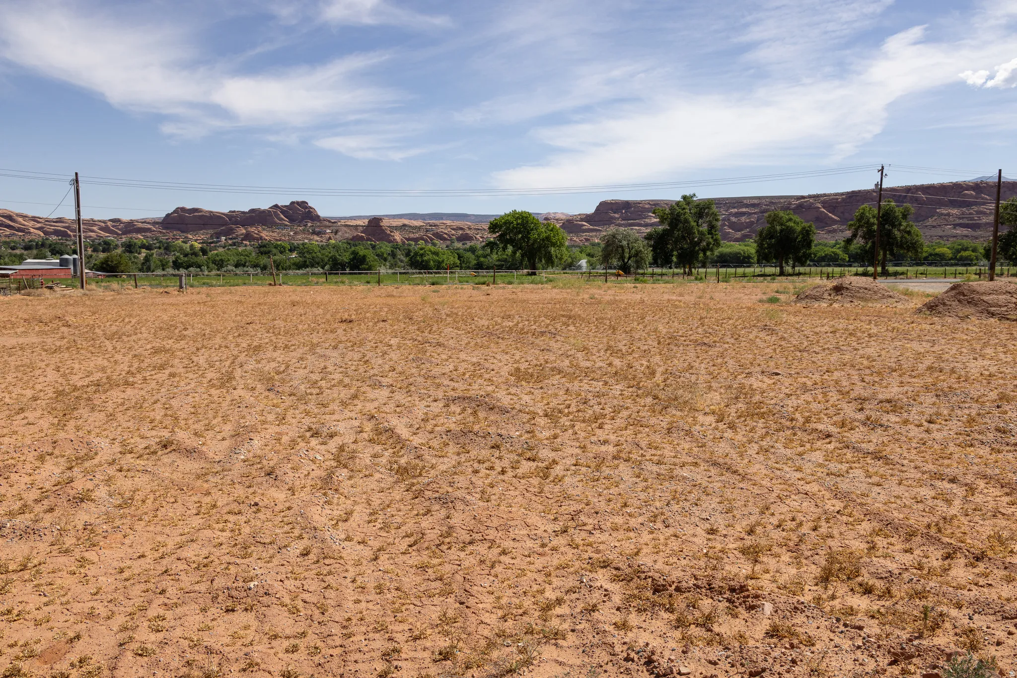 Expansive undeveloped lot featuring a natural landscape and distant red rock formations
