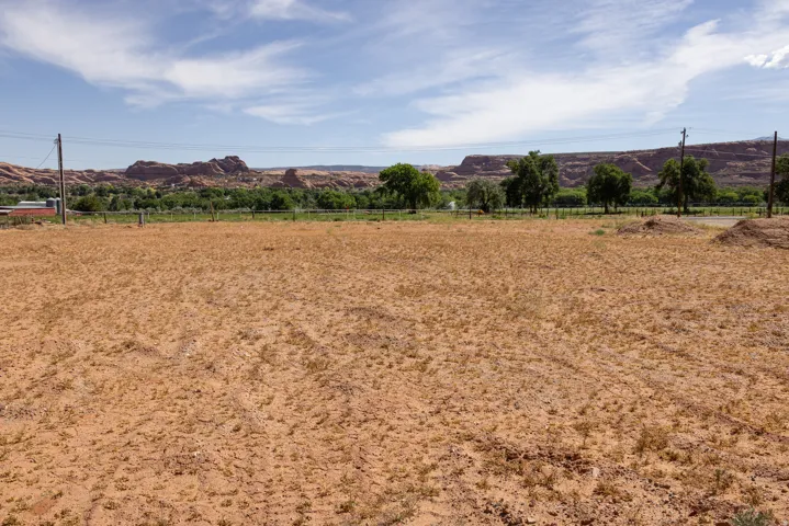 Expansive undeveloped lot featuring a natural landscape and distant red rock formations