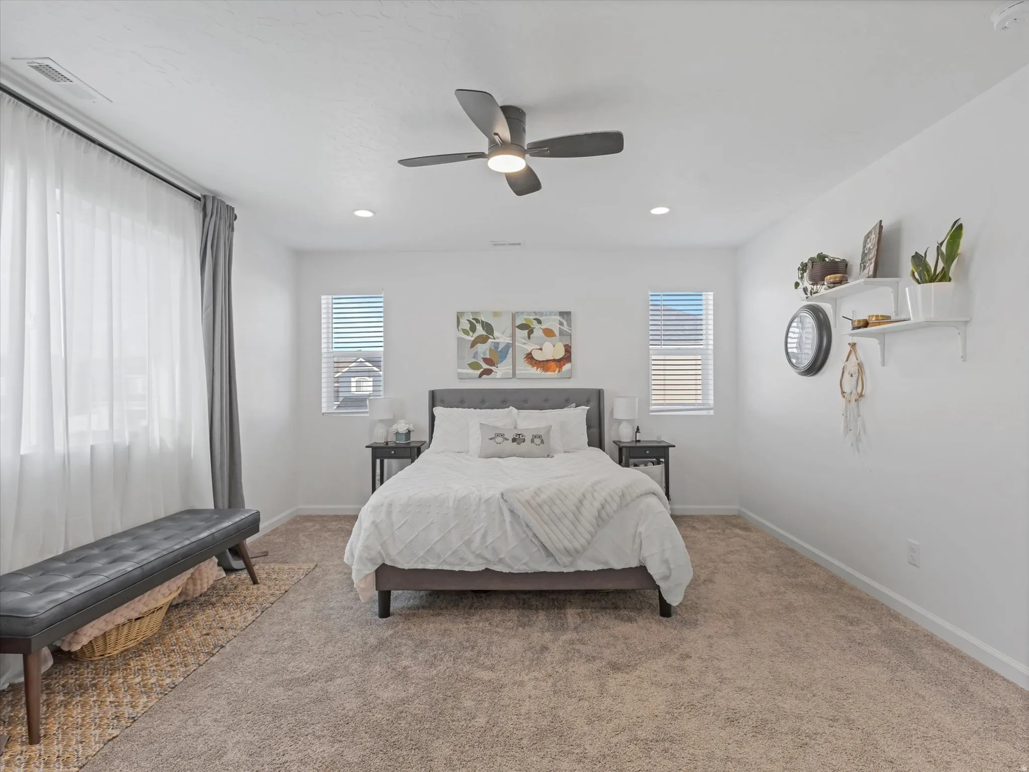 Room featuring neutral carpeting, a dark ceiling fan with integrated lighting, and recessed ceiling lights