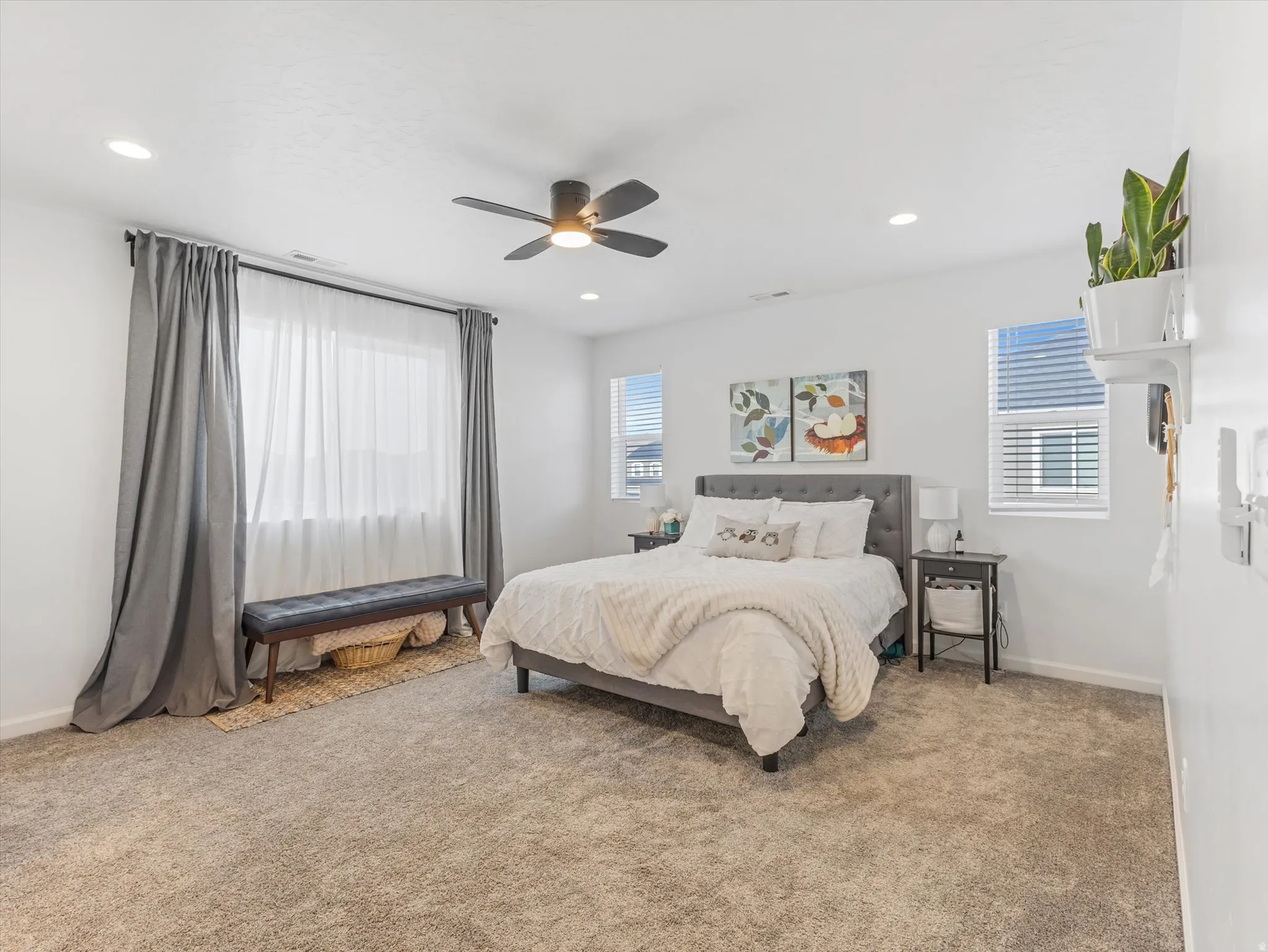 Neutral-toned carpeting and bright white walls create an inviting room